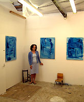 Polly Nuttall in her studio with blue paintings